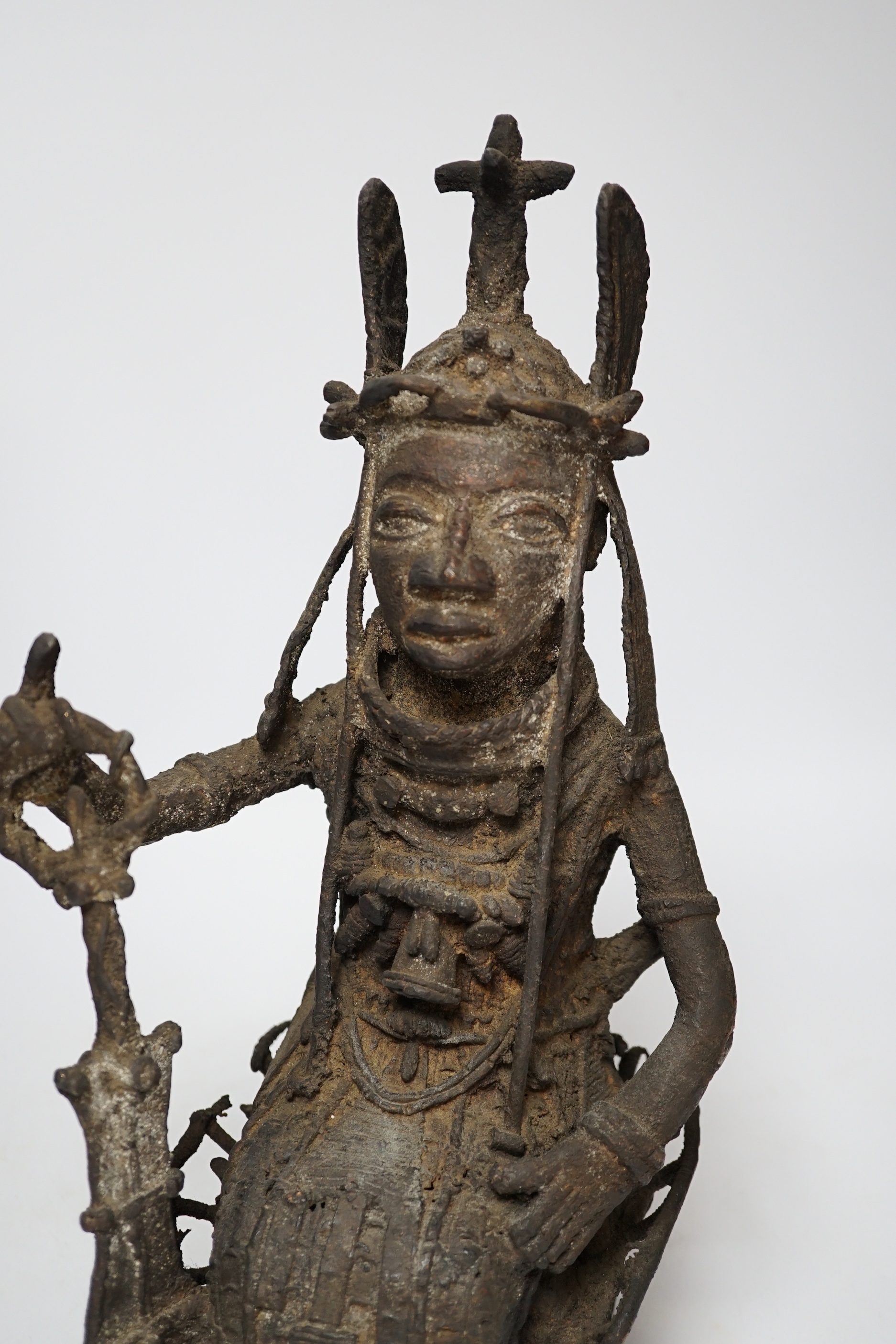 A 19th century Benin bronze of a seated figure, 38cm high